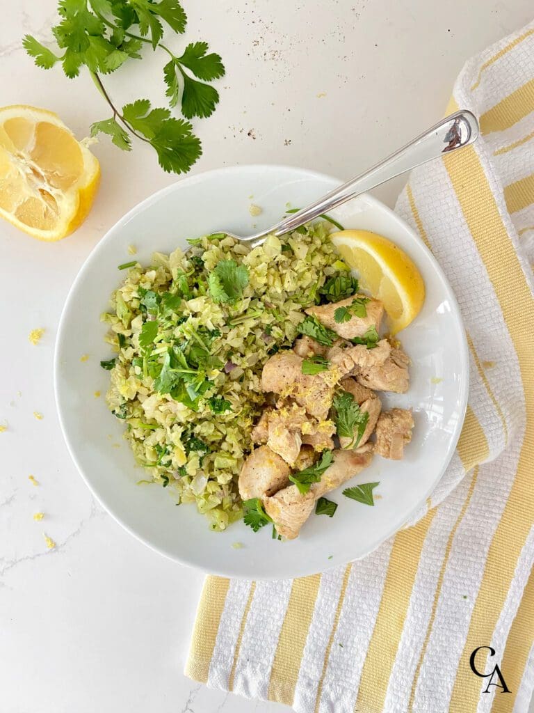 White bowl with broccoli and chicken.