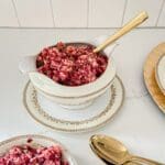 Cranberry relish in a gravy boat with a gold spoon.