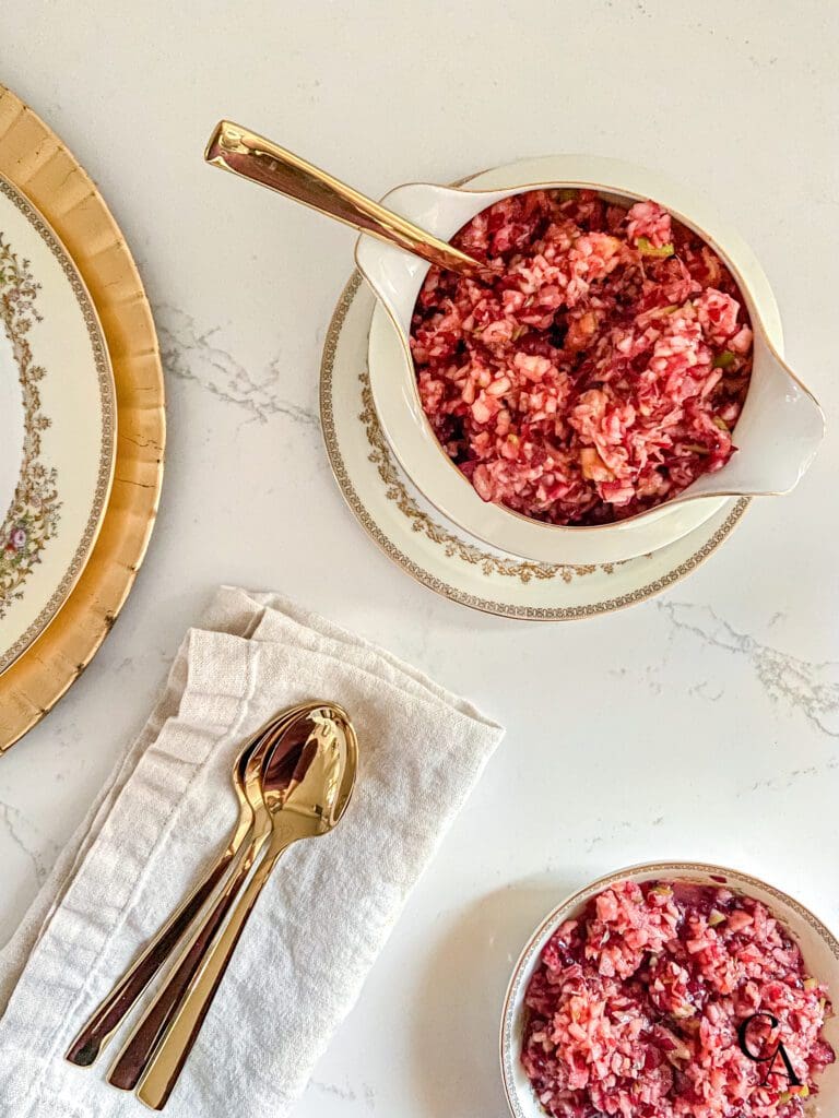 A bowl of cranberry relish on a white countertop.