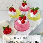 Sugar-free jello in coupe glasses with a bowls of raspberries and coconut cream.