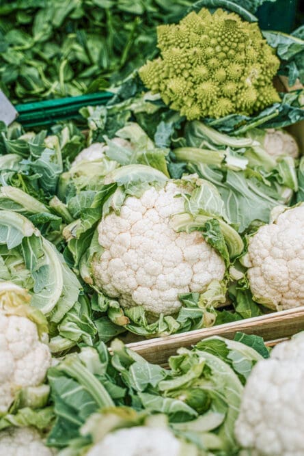 A basket of cauliflower and a head of romanesco.