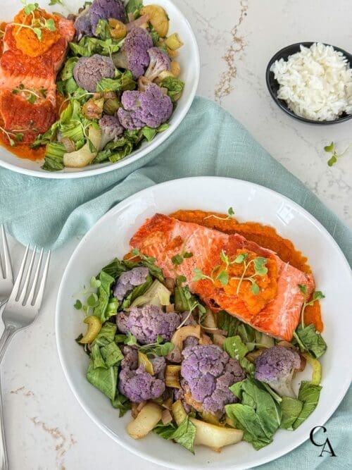 Bowls of salmon and steamed vegetables with jasmine rice.