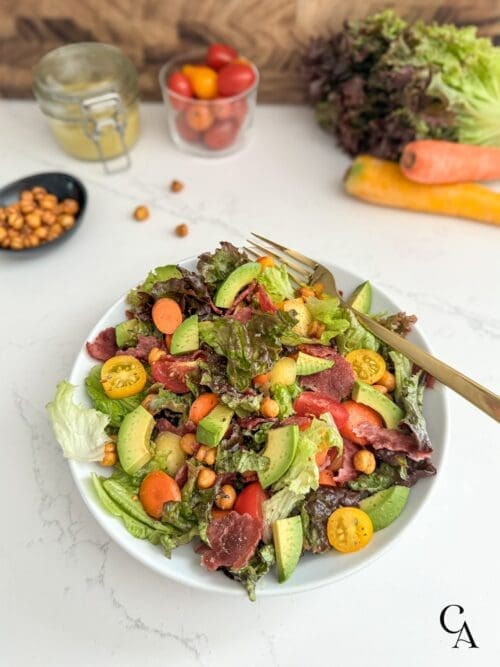 A BLT salad bowl on a white counter.