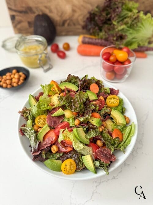 A turkey BLT salad in a white bowl.