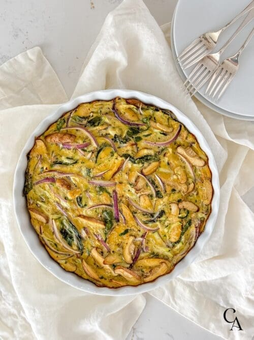 A baked frittata with silver forks.