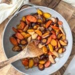 Sautéed carrots in skillet with a linen napkin.