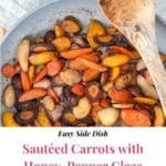 A pan of cooked carrots with a wooden spoon.