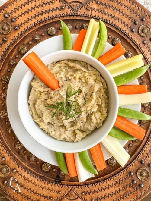 A veggie platter with a bowl of dip.