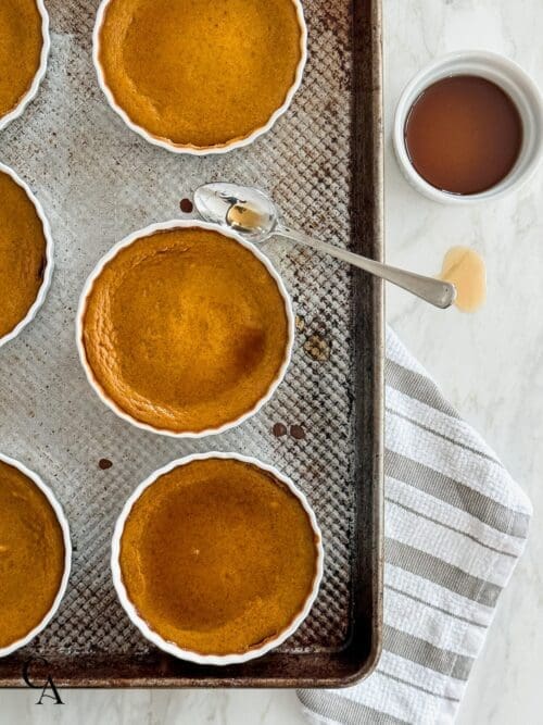 Pumpkin custards with maple syrup drizzled on top.