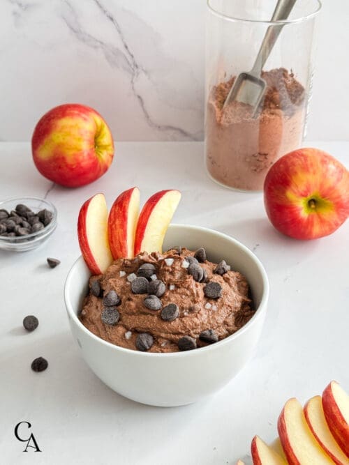 A bowl of dark chocolate hummus with chocolate chips and flaky salt.