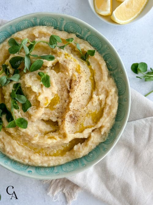 A bowl of puréed celeriac with olive oil and lemon.