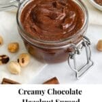 A jar of chocolate nut butter with hazelnuts and cinnamon.